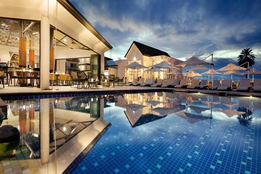 Serene outdoor thermal infinity pool overlooking majestic mountain landscape