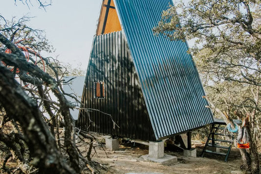 Modern A-frame cabin surrounded by a peaceful Washington forest
