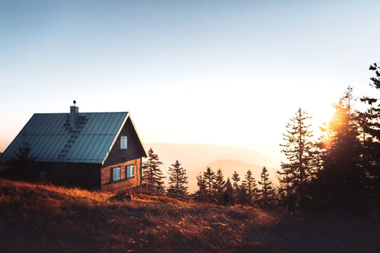 Luxury wooden treehouse nestled high in Washington evergreen forest canopy with glowing warm interior lights