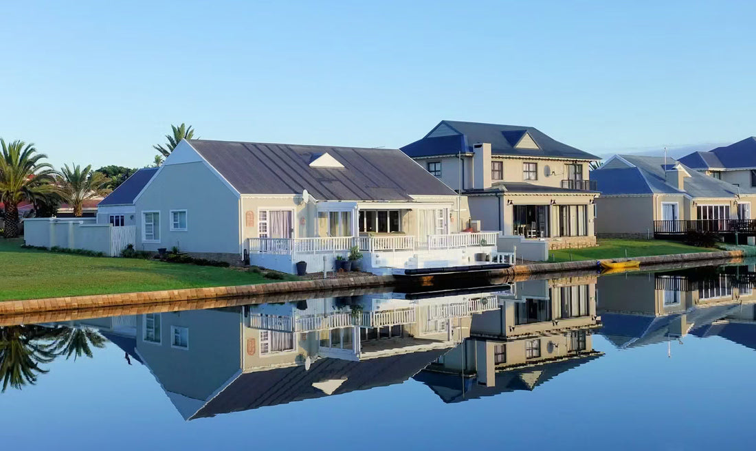 Modern luxury waterfront villa with private dock and lake views at sunset